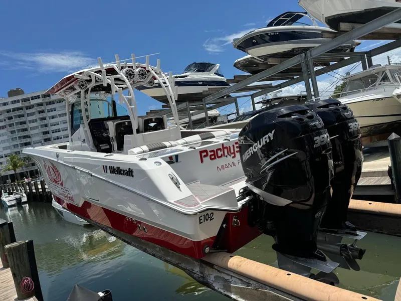 Slide: The Image of 2020 Wellcraft 302 Fisherman boat with twin Mercury engines docked at marina. - 2