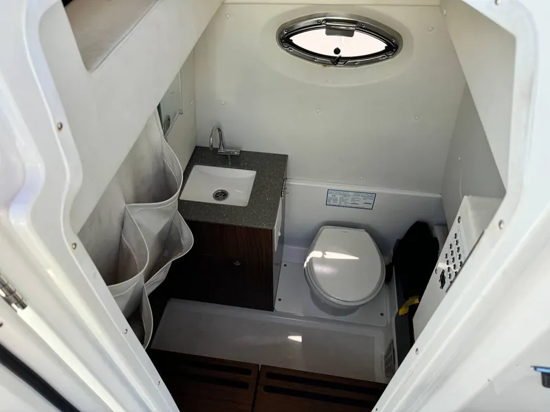 Slide: The Image of 2020 Wellcraft 302 Fisherman boat bathroom with sink and toilet. - 20