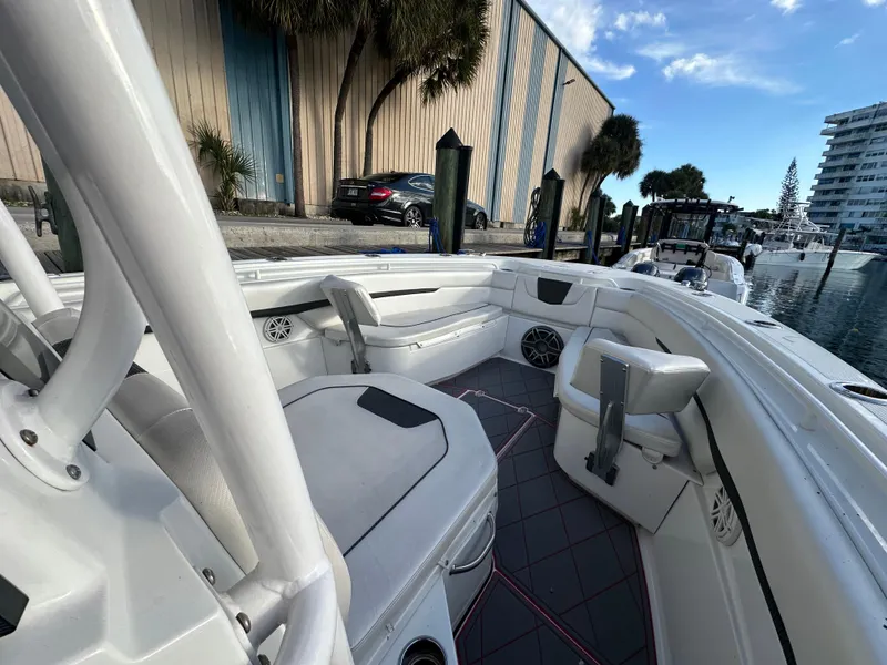 Slide: The Image of 2020 Wellcraft 302 Fisherman boat interior, featuring spacious seating and modern design at a marina. - 21