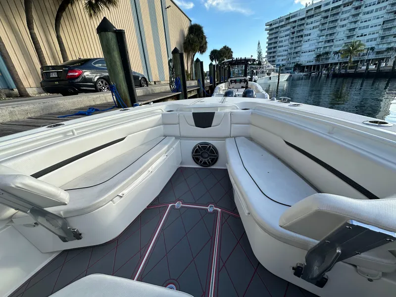 Slide: The Image of 2020 Wellcraft 302 Fisherman boat interior with seating, docked near waterfront buildings. - 22