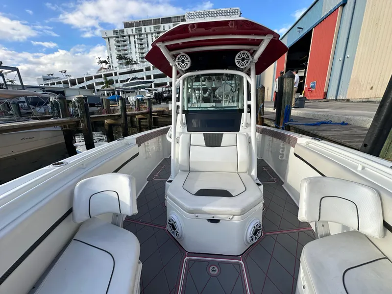 Slide: The Image of 2020 Wellcraft 302 Fisherman boat docked, featuring spacious seating and modern design. - 23