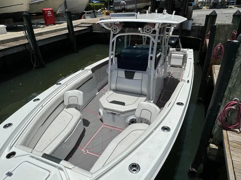 Slide: The Image of 2020 Wellcraft 302 Fisherman boat docked, featuring spacious seating and modern design. - 24