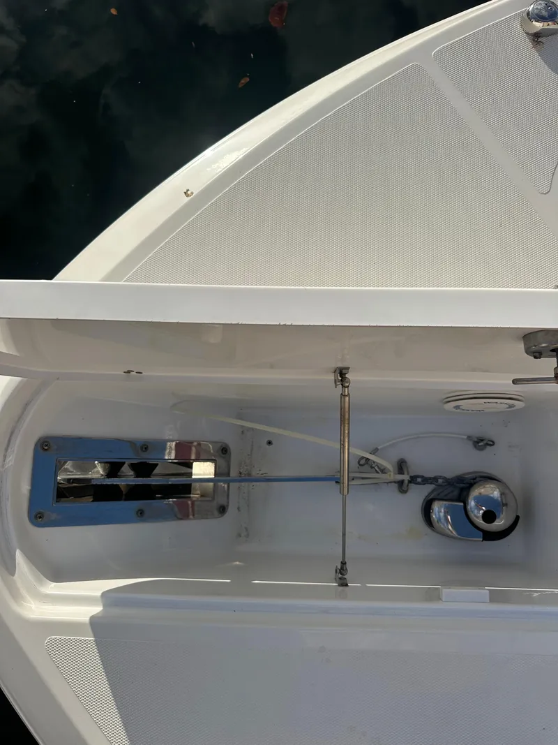 Slide: The Image of 2020 Wellcraft 302 Fisherman boat anchor compartment, featuring stainless steel hardware and clean design. - 25