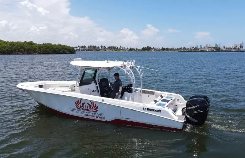 Slide: The Image of 2020 Wellcraft 302 Fisherman boat on calm water, clear sky background. - 28