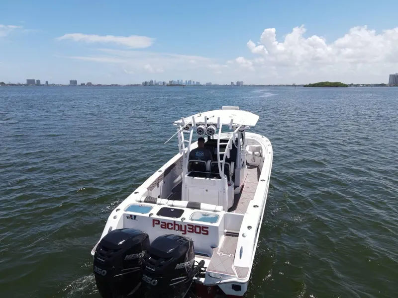 Slide: The Image of 2020 Wellcraft 302 Fisherman boat on open water with twin engines. - 29