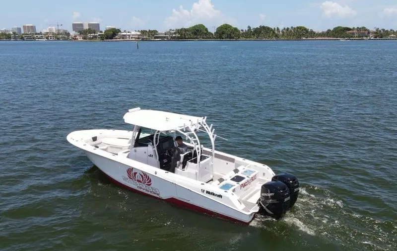 Slide: The Image of 2020 Wellcraft 302 Fisherman boat cruising on a sunny day. - 30