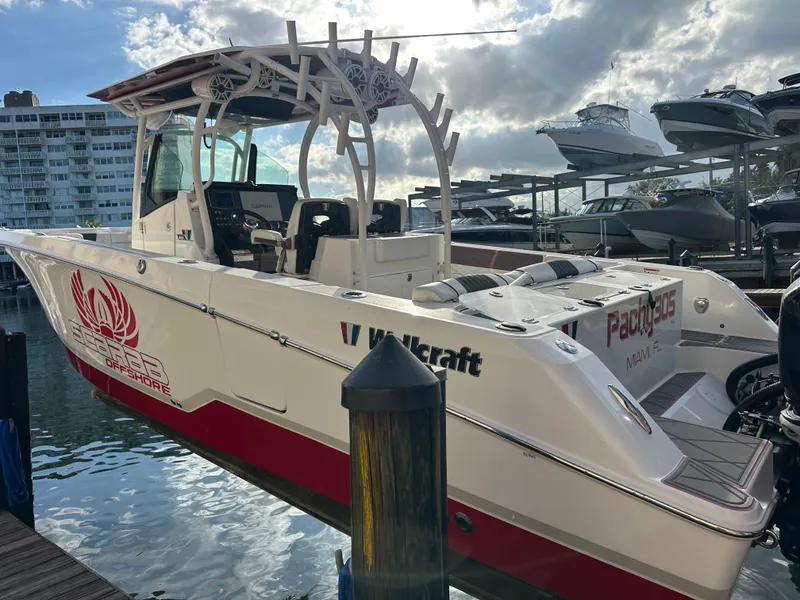 Slide: The Image of 2020 Wellcraft 302 Fisherman boat docked, featuring a sleek design and vibrant red accents. - 4