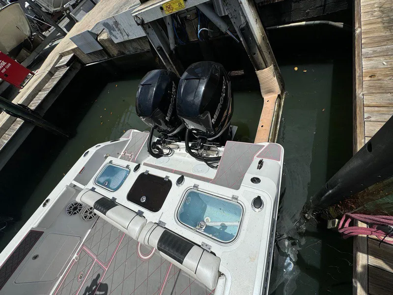 Slide: The Image of 2020 Wellcraft 302 Fisherman boat with dual outboard motors docked at marina. - 5