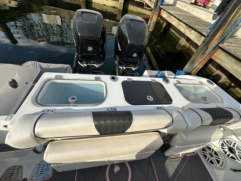 Slide: The Image of 2020 Wellcraft 302 Fisherman boat with dual outboard motors and cushioned seating at the dock. - 6