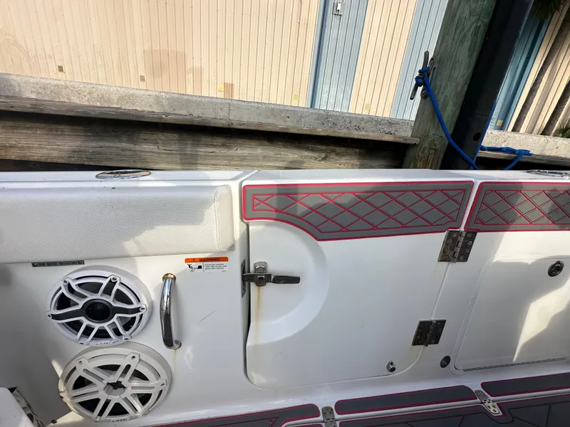 Slide: The Image of 2020 Wellcraft 302 Fisherman boat interior with speakers and storage compartment. - 8