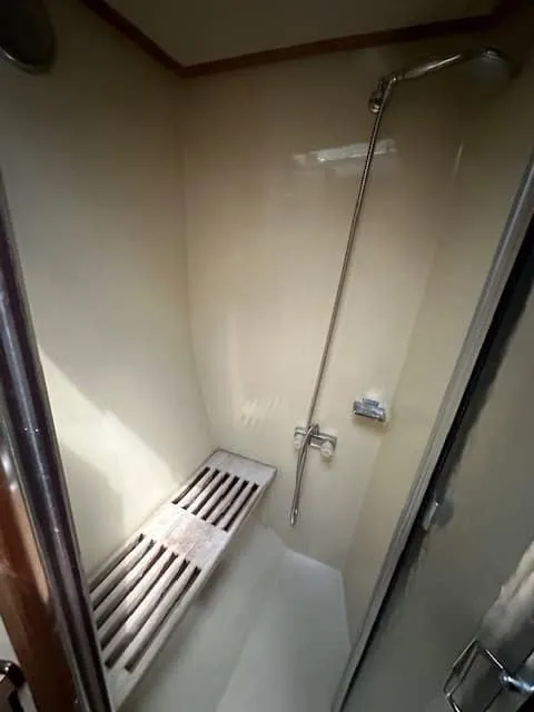 Slide: The Image of 1985 Trojan T36 boat shower with bench and handheld showerhead. - 11