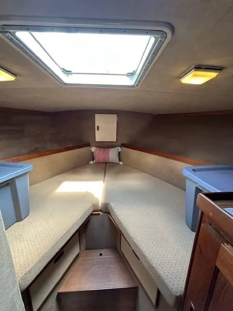 Slide: The Image of 1985 Trojan T36 boat interior cabin with V-berth and storage compartments. - 12