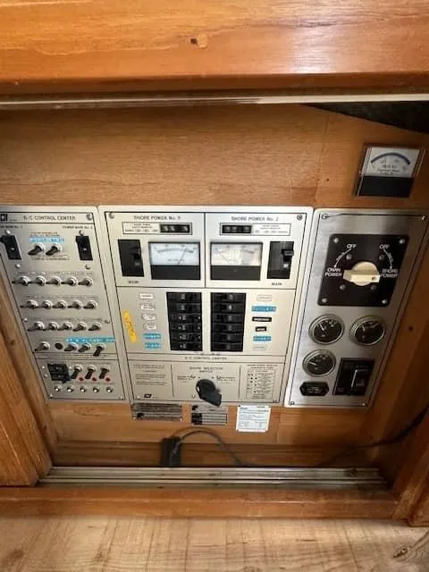 Slide: The Image of 1985 Trojan T36 control panel with shore power and electrical switches. - 14