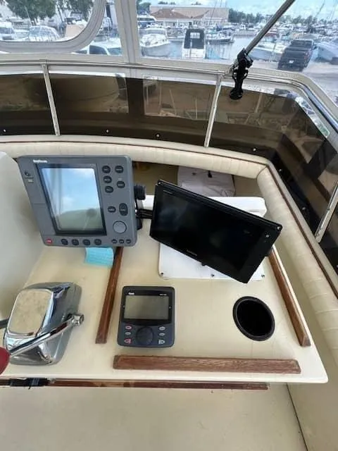 Slide: The Image of 1985 Trojan T36 boat dashboard with navigation equipment and controls. - 19