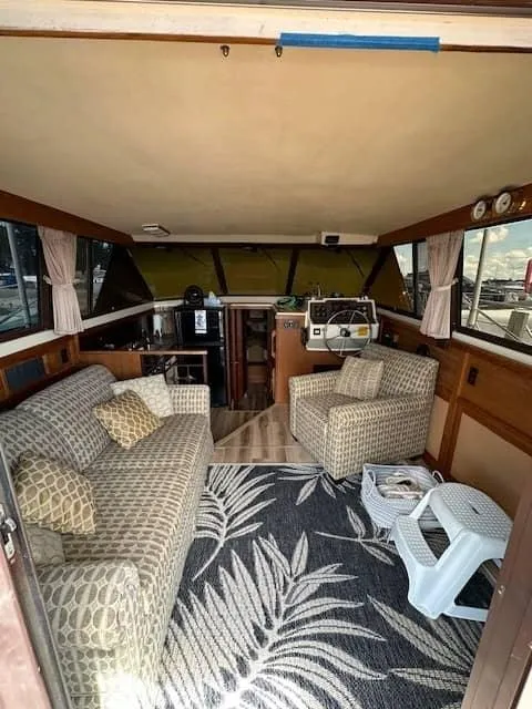 Slide: The Image of 1985 Trojan T36 boat interior with cozy seating and nautical decor. - 2