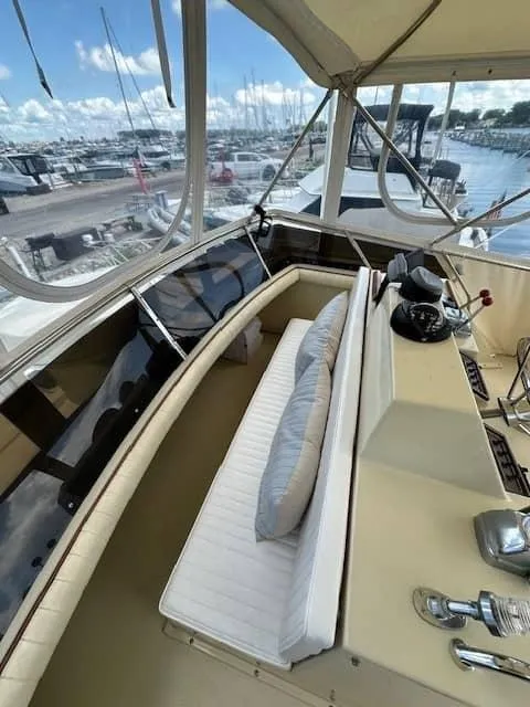 Slide: The Image of 1985 Trojan T36 yacht interior with helm and seating area. - 20