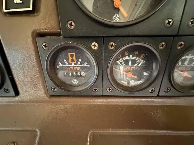 Slide: The Image of 1985 Trojan F36 dashboard with hour and volt meters. - 21