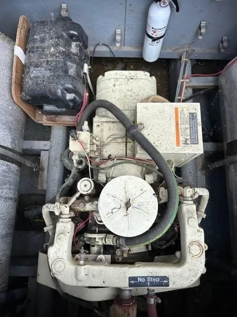 Slide: The Image of 1985 Trojan T36 engine compartment with visible components and fire extinguisher. - 23