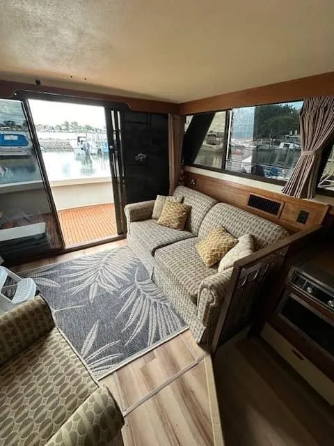 Slide: The Image of Interior of 1985 Trojan T36 boat with cozy seating and waterfront view. - 5