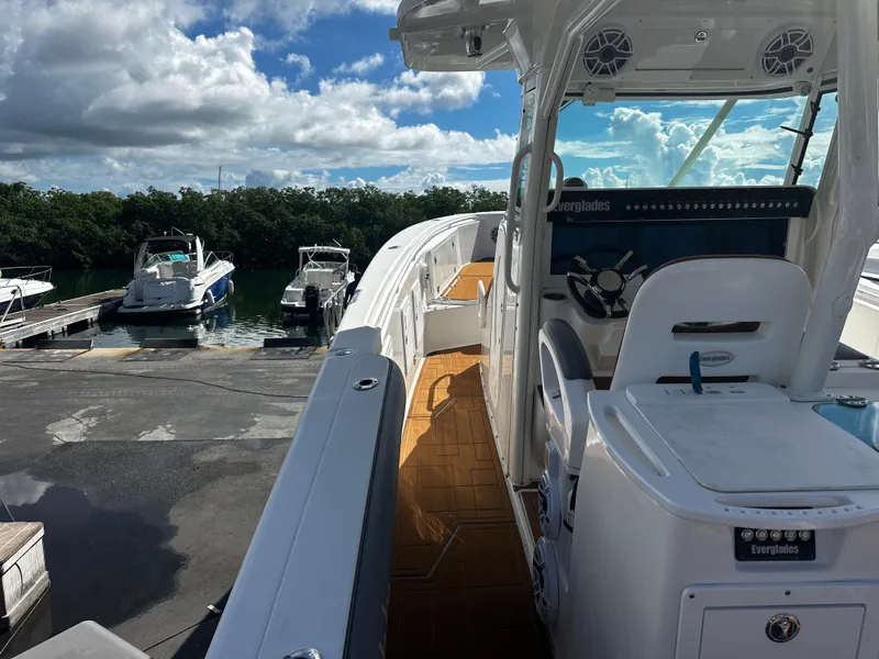 Slide: The Image of 2008 Everglades 350 CC boat docked at marina with other boats in background. - 15