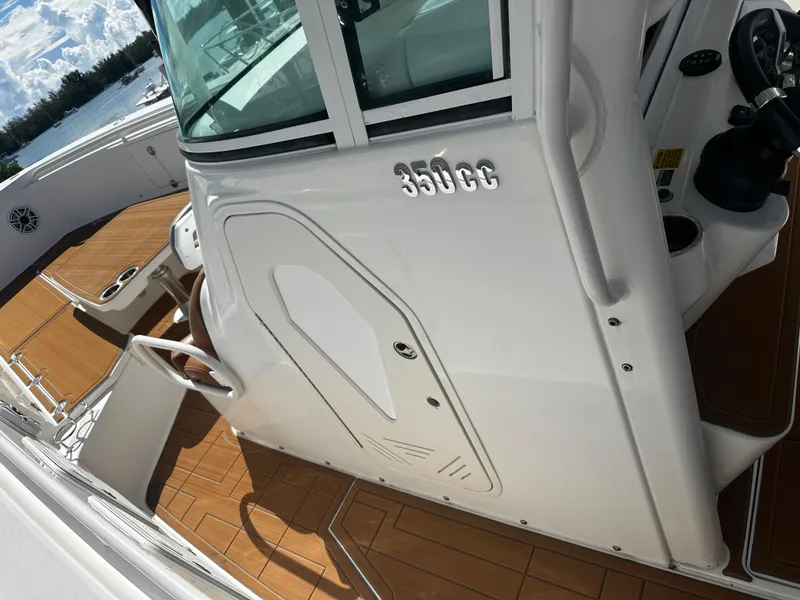 Slide: The Image of 2008 Everglades 350 CC boat with teak deck and white cabin. - 19