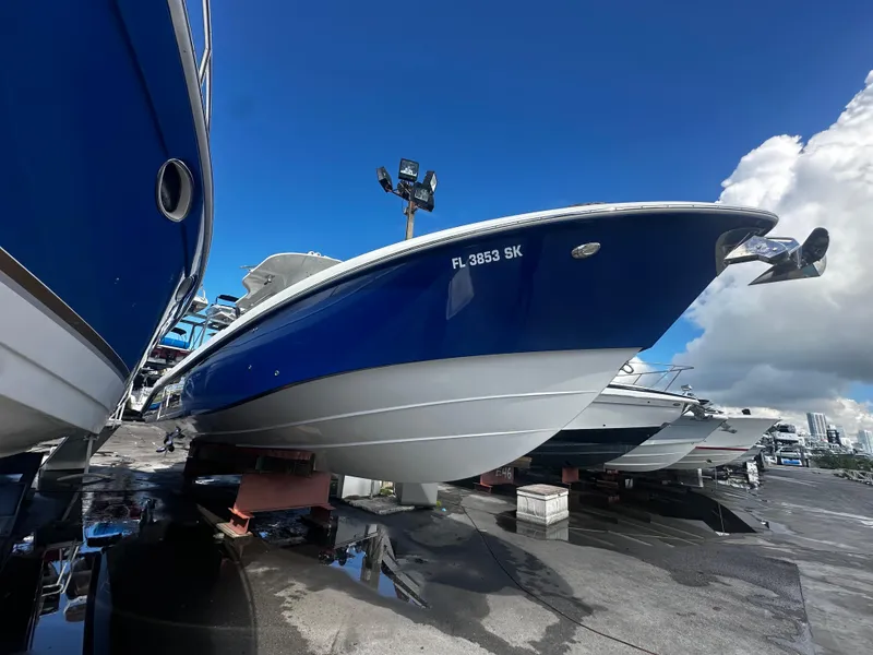 Slide: The Image of 2008 Everglades 350 CC boat in dry dock, blue and white hull. - 2