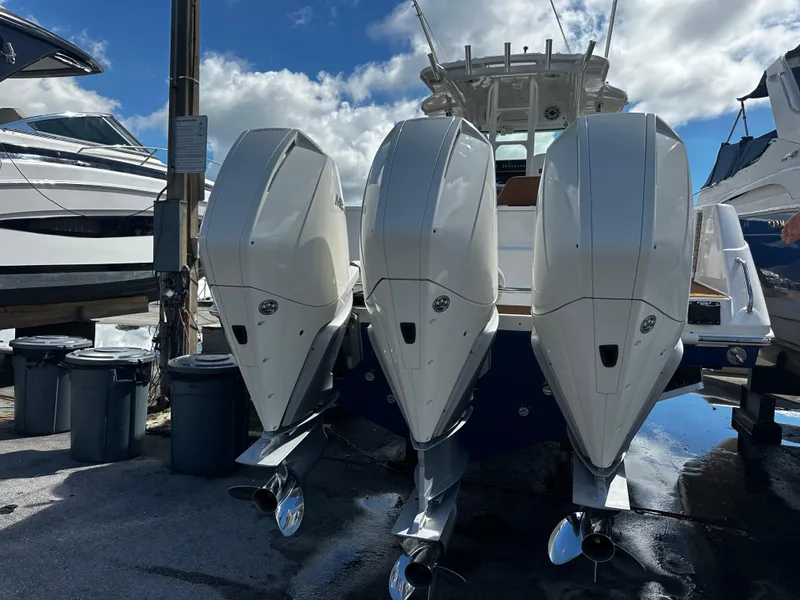 Slide: The Image of 2008 Everglades 350 CC boat with triple outboard engines docked at marina. - 4