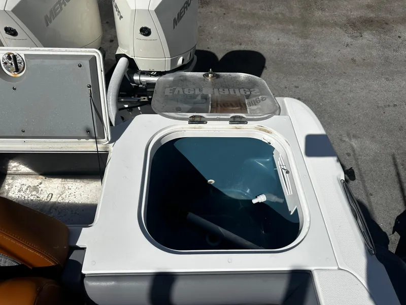 Slide: The Image of 2008 Everglades 350 CC boat livewell with open lid and Mercury engines in background. - 7