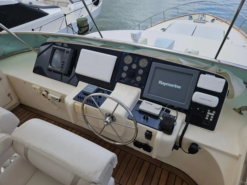 Slide: The Image of Astondoa 72 GLX 1998 yacht helm with Raymarine navigation system and wooden deck. - 11