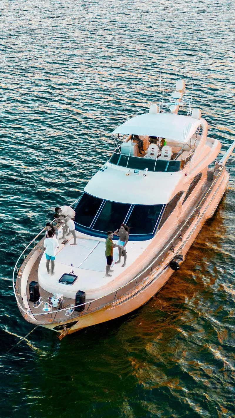 Slide: The Image of Astondoa 72 GLX yacht on water, 1998 model, with people on deck. - 2