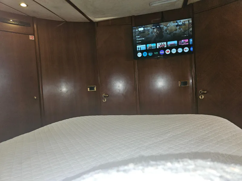 Slide: The Image of Interior of 1998 Astondoa 72 GLX yacht cabin with TV and wooden paneling. - 49