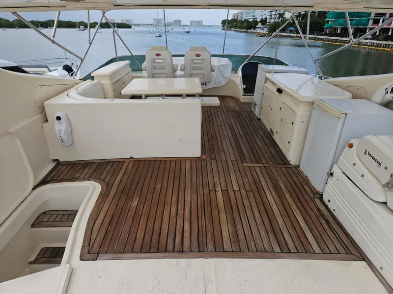 Slide: The Image of Astondoa 72 GLX yacht deck with seating, table, and scenic water view, 1998 model. - 5