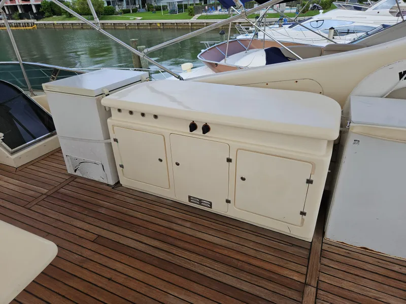 Slide: The Image of Astondoa 72 GLX 1998 yacht deck with wooden flooring and storage cabinets. - 8