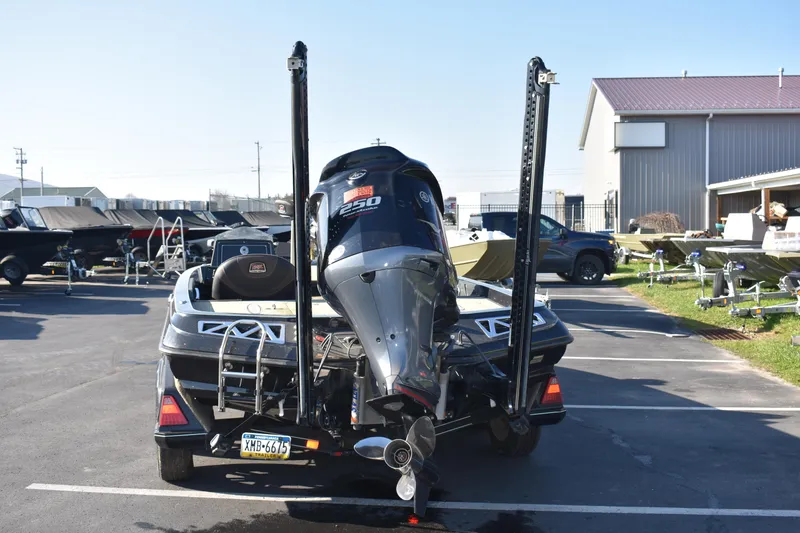 Slide: The Image of 2019 Ranger Z521L bass boat with outboard motor in a parking lot. - 3