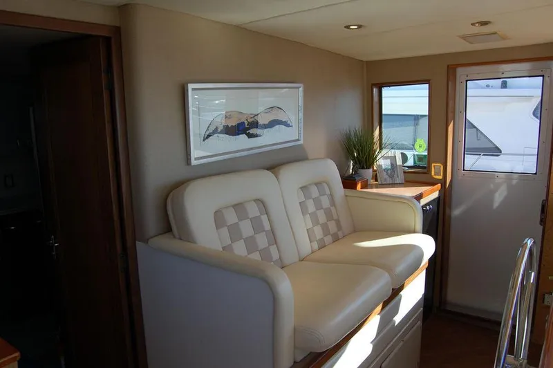 Slide: The Image of Interior of 1990 Hatteras 78 Aft Cockpit Motoryacht with seating and decor. - 11
