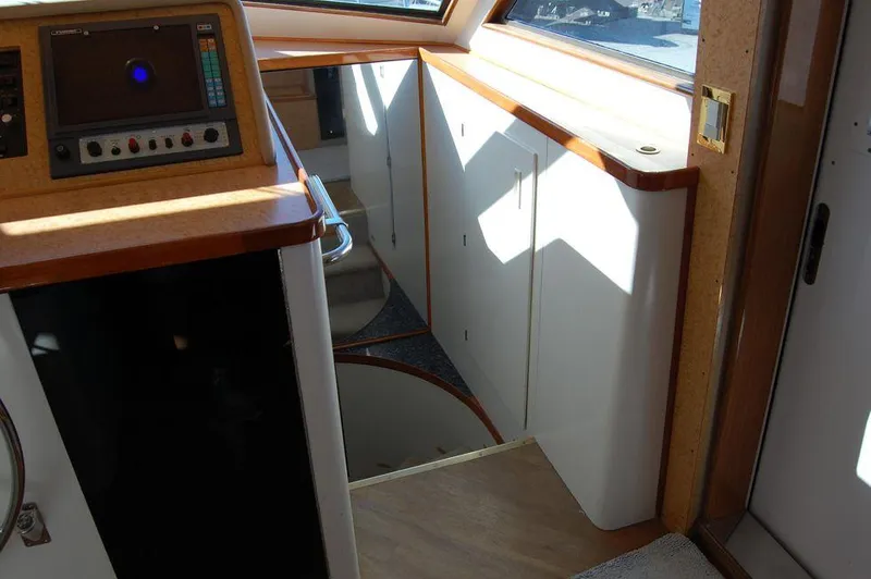 Slide: The Image of Interior of 1990 Hatteras 78 Aft Cockpit Motoryacht with stairs and control panel. - 14