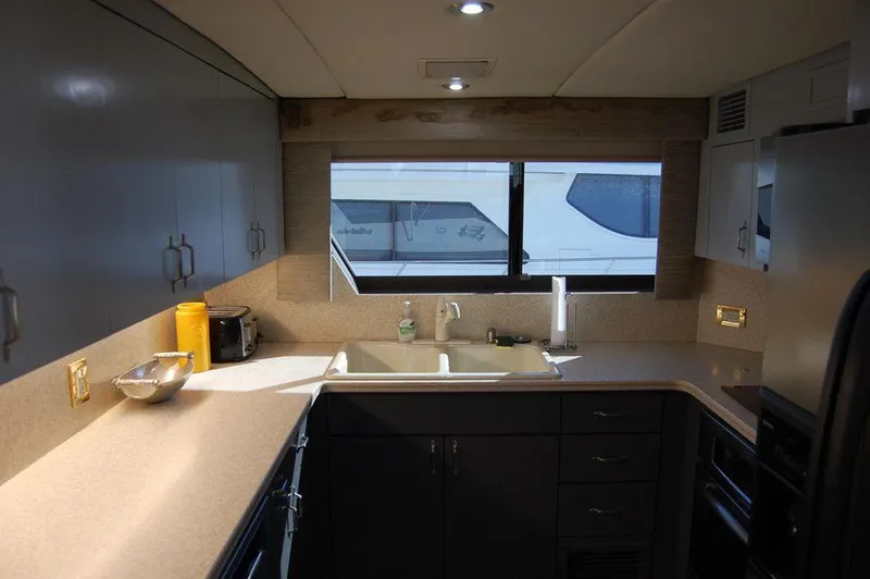 Slide: The Image of Modern kitchen interior of 1990 Hatteras 78 Aft Cockpit Motoryacht with ample counter space. - 15