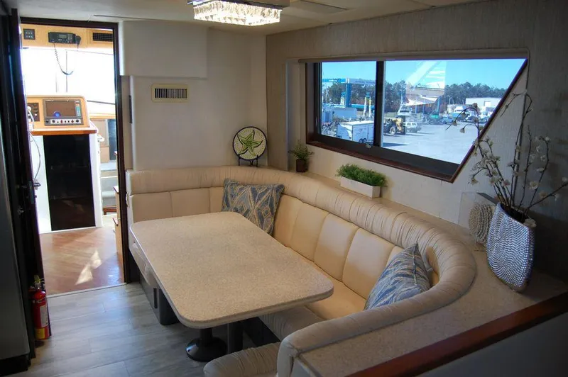 Slide: The Image of Interior of 1990 Hatteras 78 Aft Cockpit Motoryacht with dining area and large window. - 16