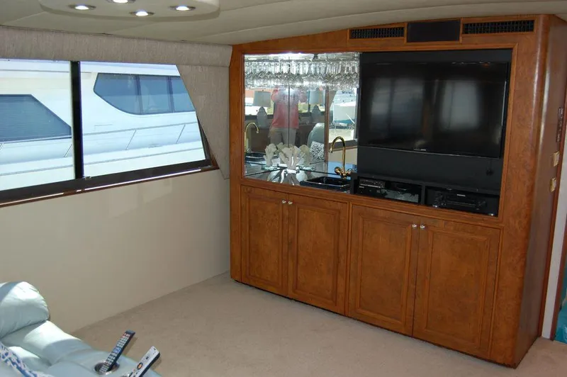Slide: The Image of Interior of 1990 Hatteras 78 Aft Cockpit Motoryacht with entertainment center and large window. - 19