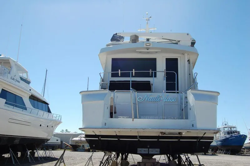 Slide: The Image of 1990 Hatteras 78 Aft Cockpit Motoryacht on dry dock, rear view. - 2