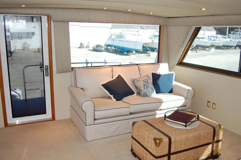 Slide: The Image of Interior of 1990 Hatteras 78 Aft Cockpit Motoryacht with sofa and wicker coffee table. - 20