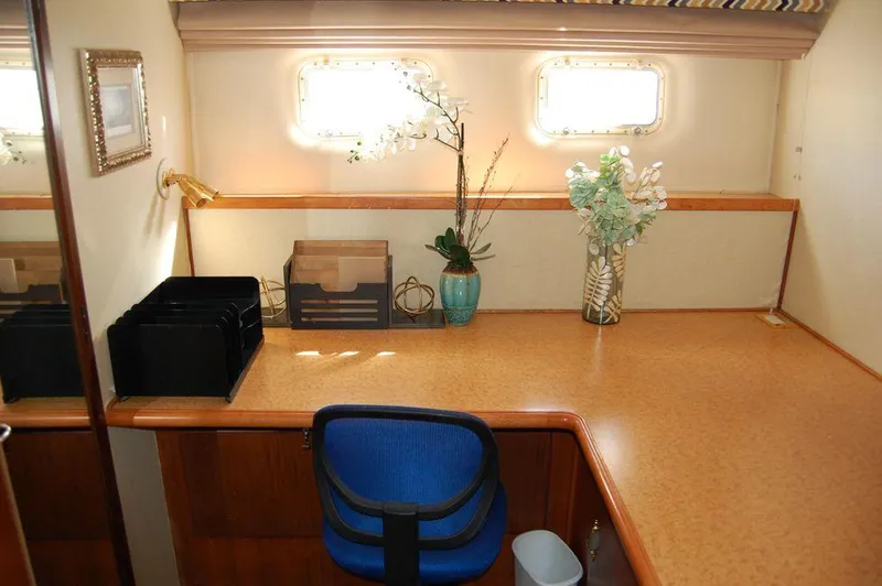 Slide: The Image of Office space on 1990 Hatteras 78 Aft Cockpit Motoryacht with desk and decor. - 27