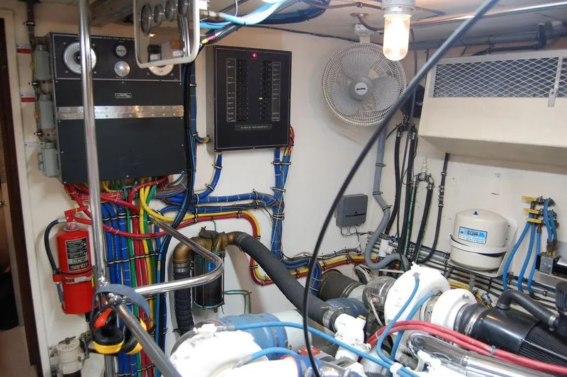 Slide: The Image of Engine room of a 1990 Hatteras 78 Aft Cockpit Motoryacht with wiring and machinery. - 29