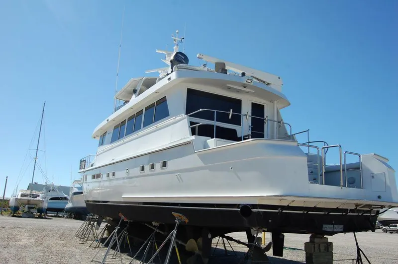 Slide: The Image of 1990 Hatteras 78 Aft Cockpit Motoryacht on dry dock for maintenance. - 3