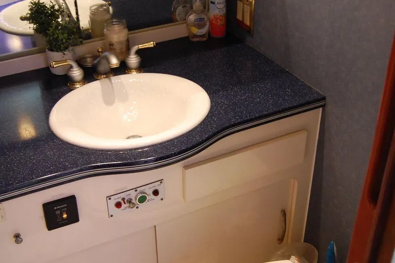 Slide: The Image of Bathroom sink area on a 1990 Hatteras 78 Aft Cockpit Motoryacht. - 42