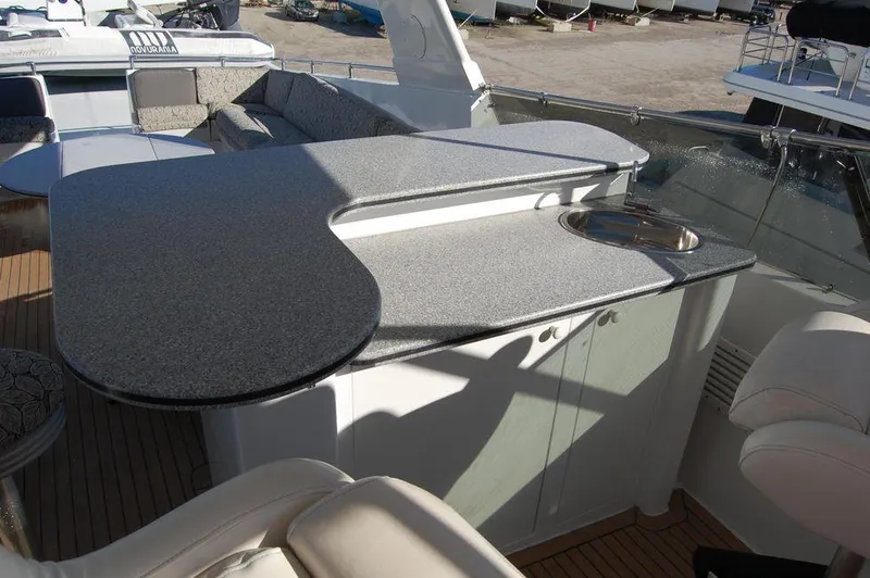 Slide: The Image of 1990 Hatteras 78 Aft Cockpit Motoryacht outdoor seating and bar area. - 8