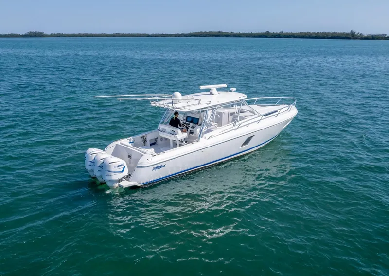 Slide: The Image of 2011 Intrepid 400 Cuddy boat cruising on open water. - 1