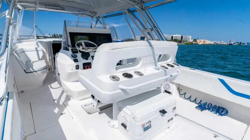 Slide: The Image of 2011 Intrepid 400 Cuddy boat interior with helm station and ocean view. - 15