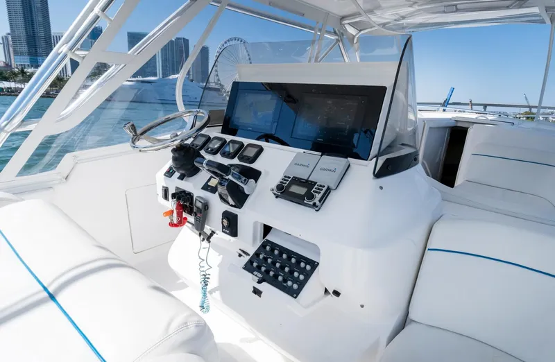Slide: The Image of 2011 Intrepid 400 Cuddy helm with modern navigation equipment and waterfront city view. - 17