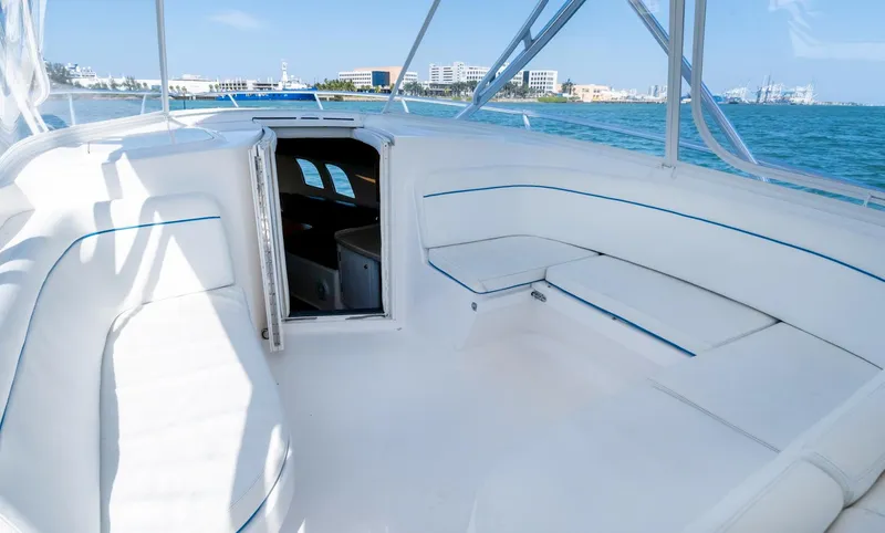 Slide: The Image of 2011 Intrepid 400 Cuddy boat interior with white seating and ocean view. - 18